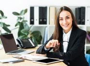 confident-happy-young-businesswoman-sitting-office-desk_23-2147943726
